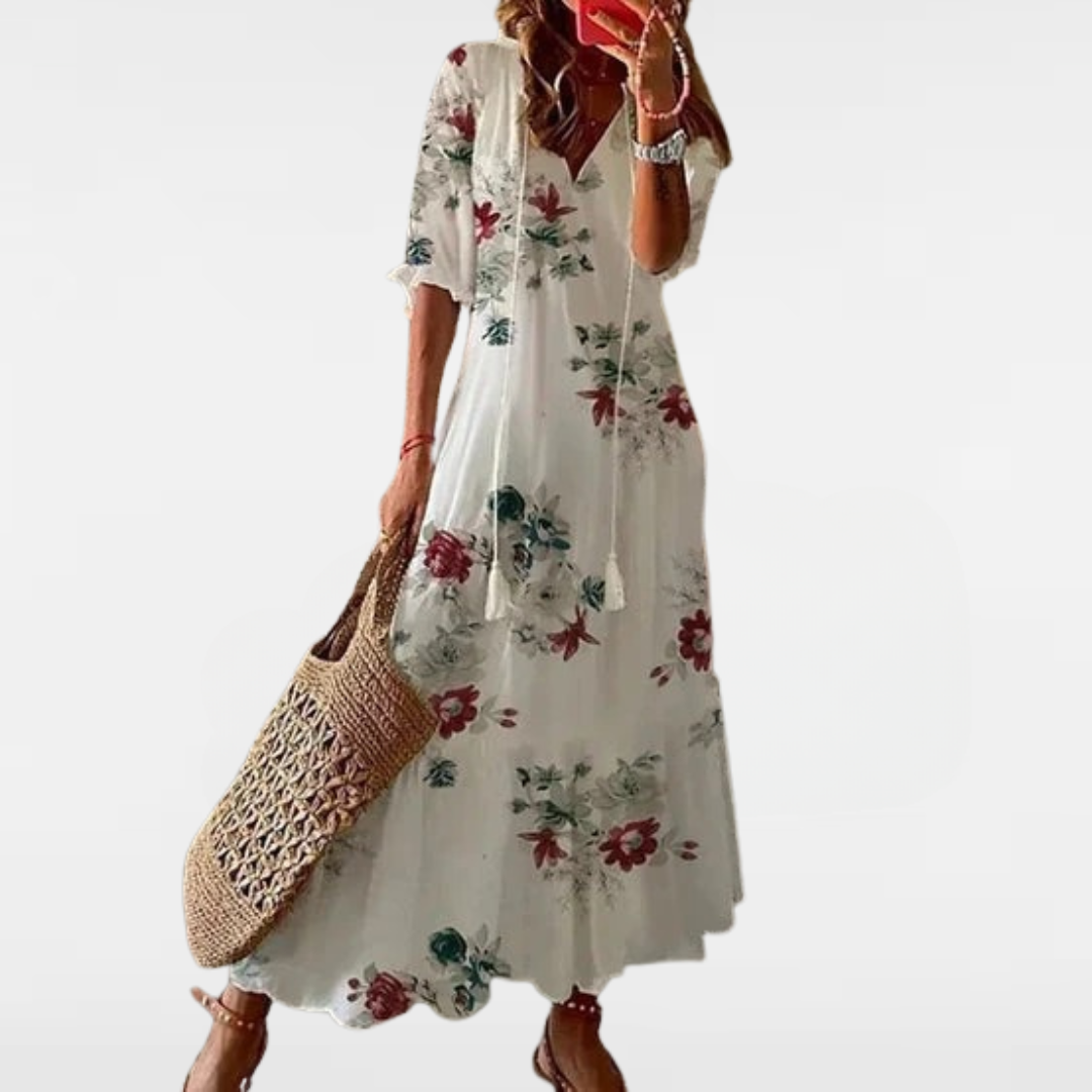 Loose bohemian dress in white with red, green, and blue floral print, short sleeves