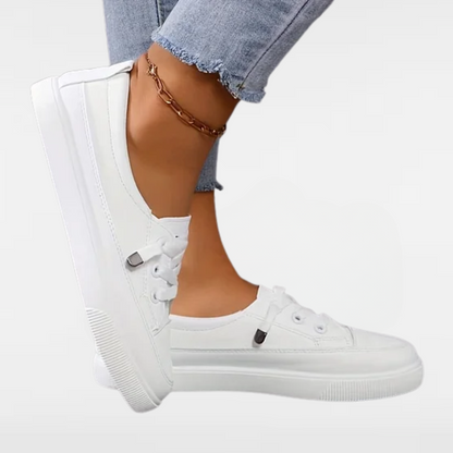 White lace-up orthopedic sneakers with cushioned sole and side strap detail