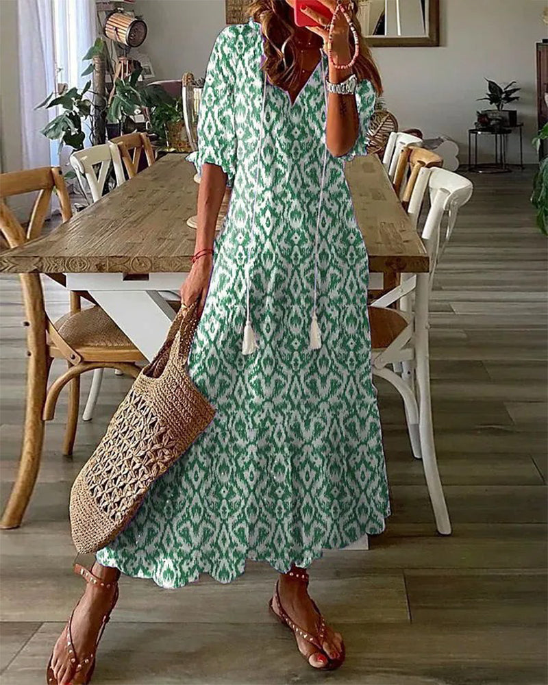 Loose bohemian dress in green with repeating diamond pattern, tiered hem