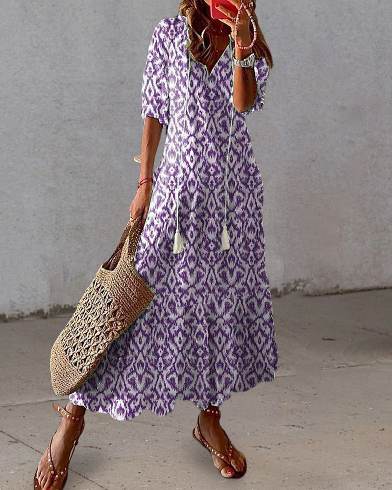 Loose bohemian dress in purple with repeating diamond pattern, short sleeves