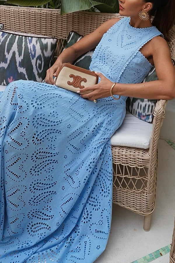 Blue embroidered sleeveless crop top and high-waist maxi skirt set, seated side view