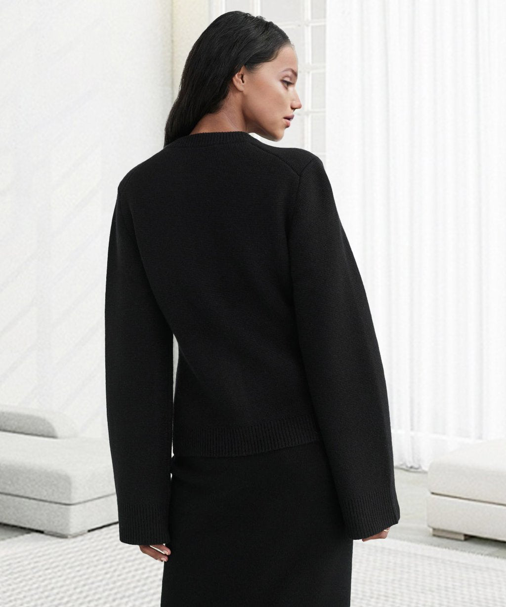 Black cardigan with ribbed back hem and long sleeves