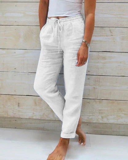 White drawstring pants with elastic waist and cuffed ankles, relaxed fit