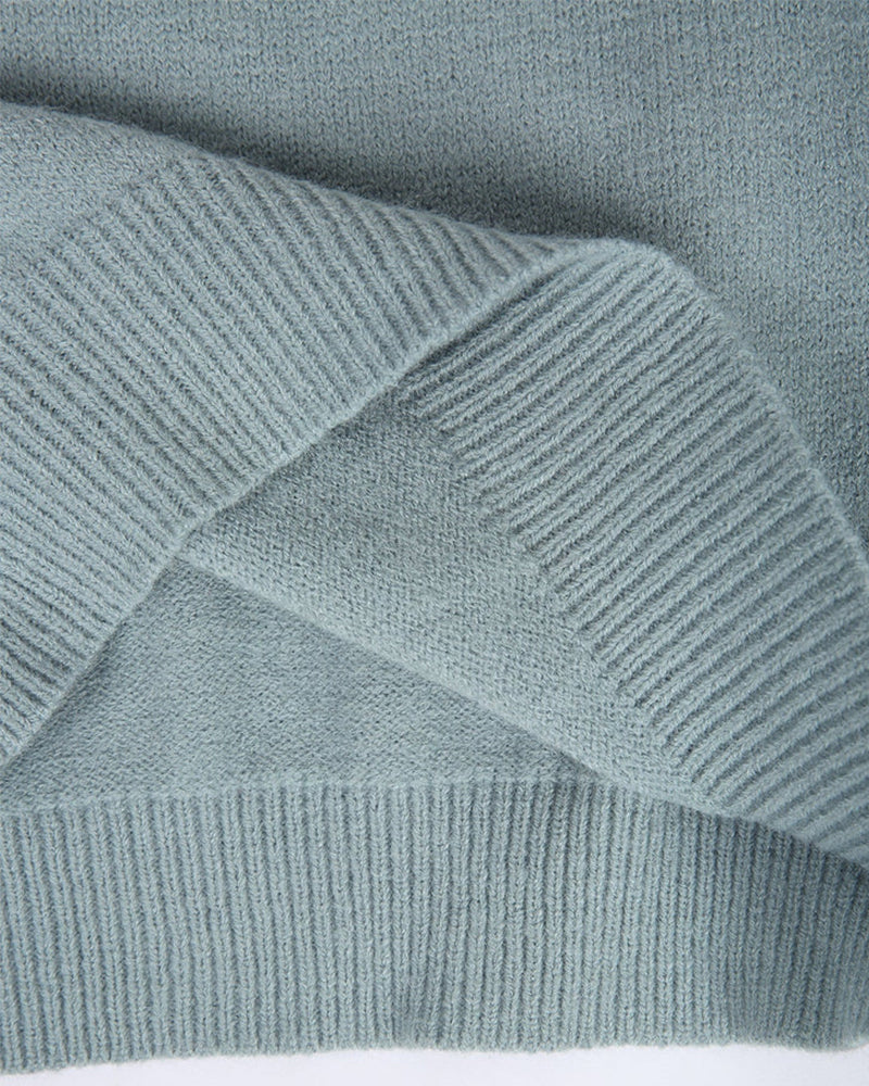 Teal Fair Isle knit sweater fabric close-up with ribbed knit texture