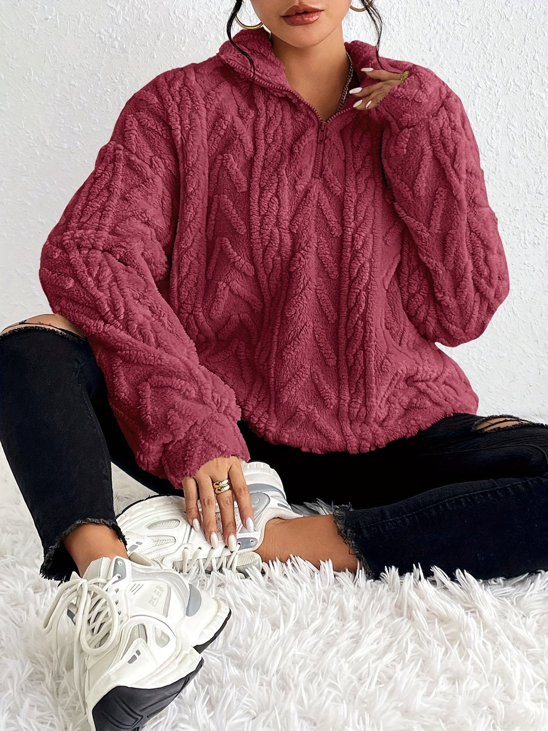 Warm knit quarter-zip sweater in burgundy with cable texture, stand collar, long sleeves.