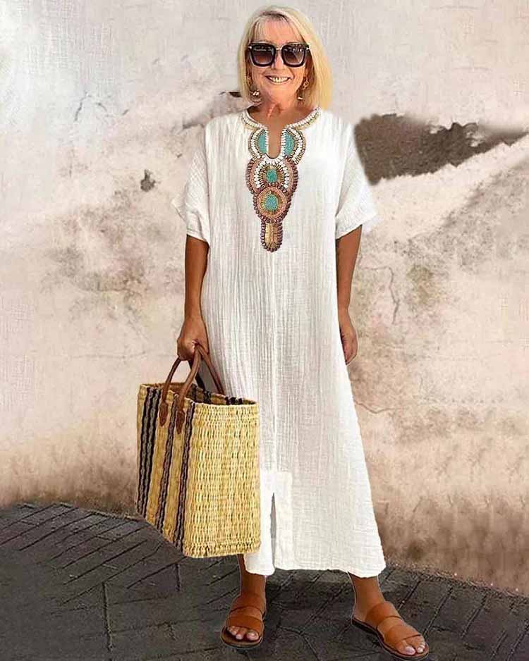 White embroidered midi dress with short sleeves and central ornamental placket