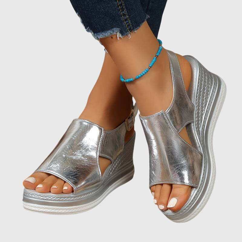 Silver metallic orthopedic sandals with open toe and ankle strap, cushioned platform sole