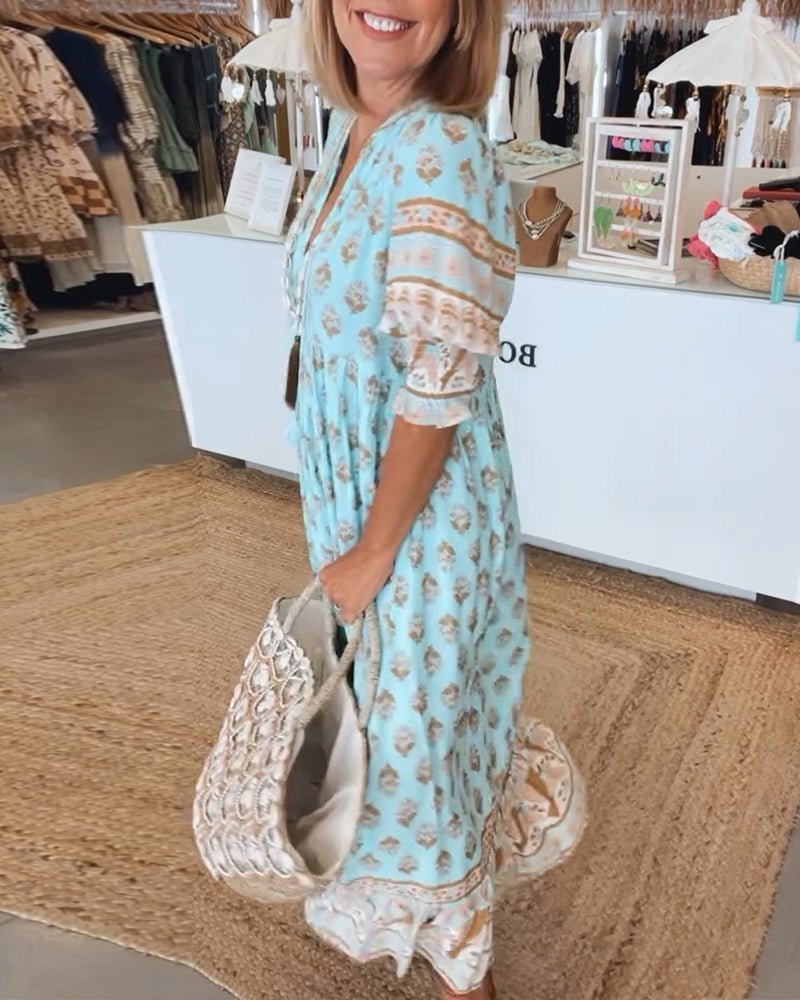 Blue floral V-neck dress with lace-trim sleeves and ruffled hem, tiered design