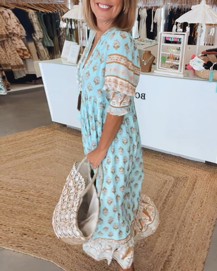 Blue floral V-neck dress with lace-trim sleeves and ruffled hem, tiered design