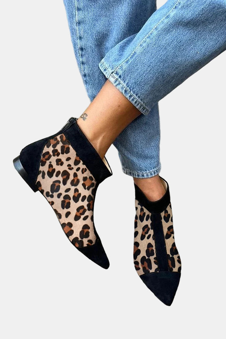 Pointed toe ankle boots with leopard print panels and black trim.