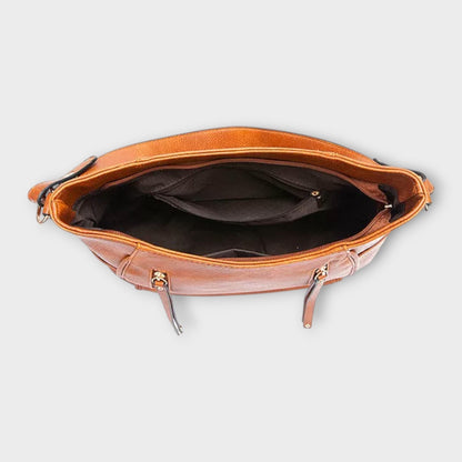 Tan leather hobo handbag open top view with dark lining and zip closure.