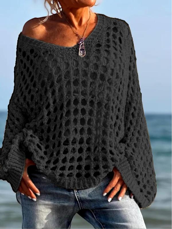 Comfy long-sleeve knit top in black with openwork pattern and fringe trim