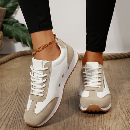 Casual low-top sneakers, cream white with beige accents, lace-up and ankle chain.