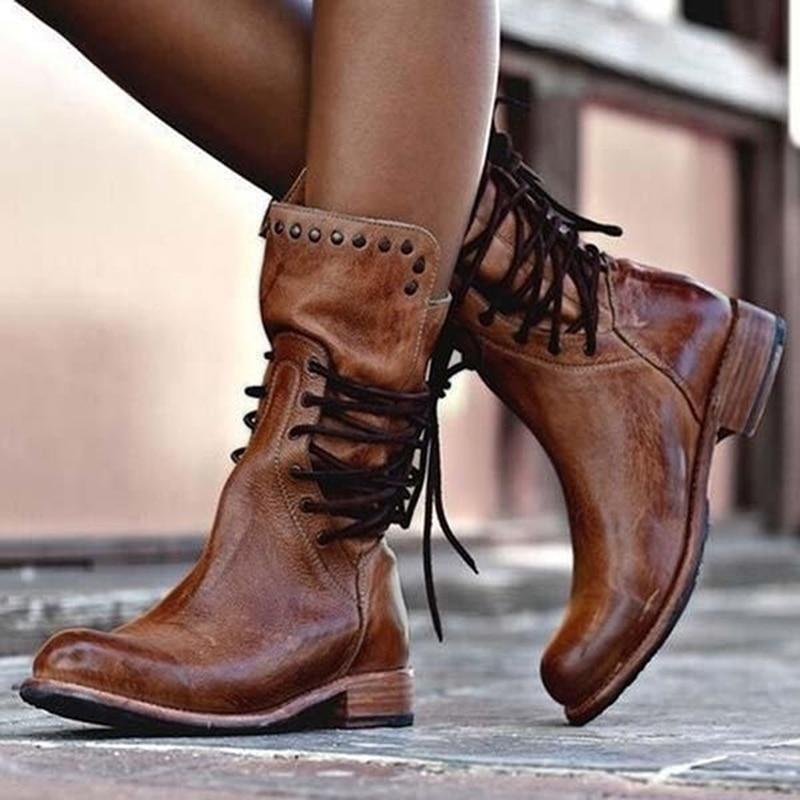 Brown leather lace-up boots with studded top band and stacked low heel.