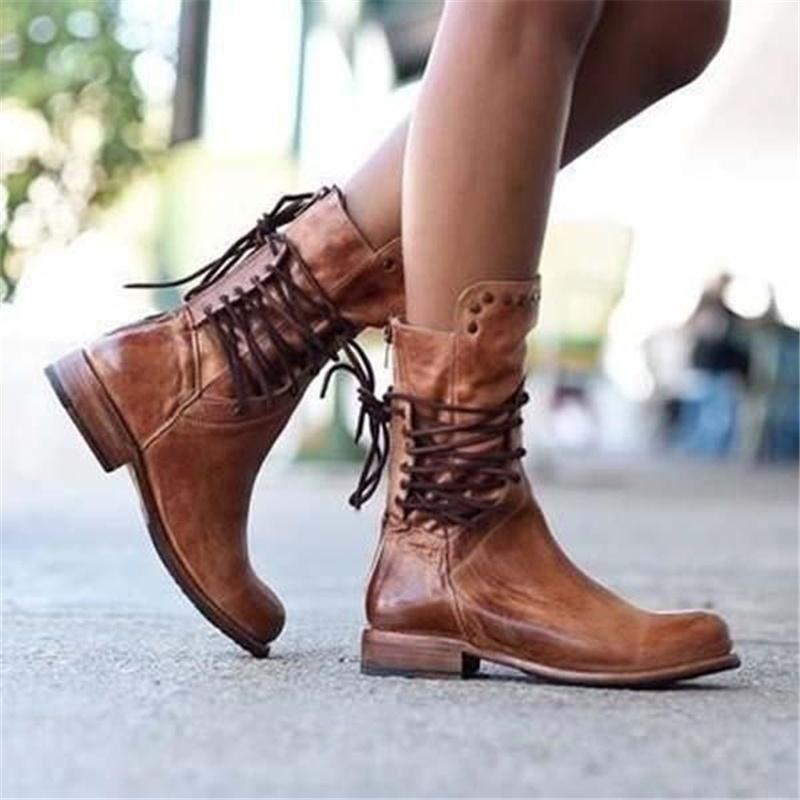 Brown leather lace-up boots with eyelet lacing, studded cuff, and flat heel.
