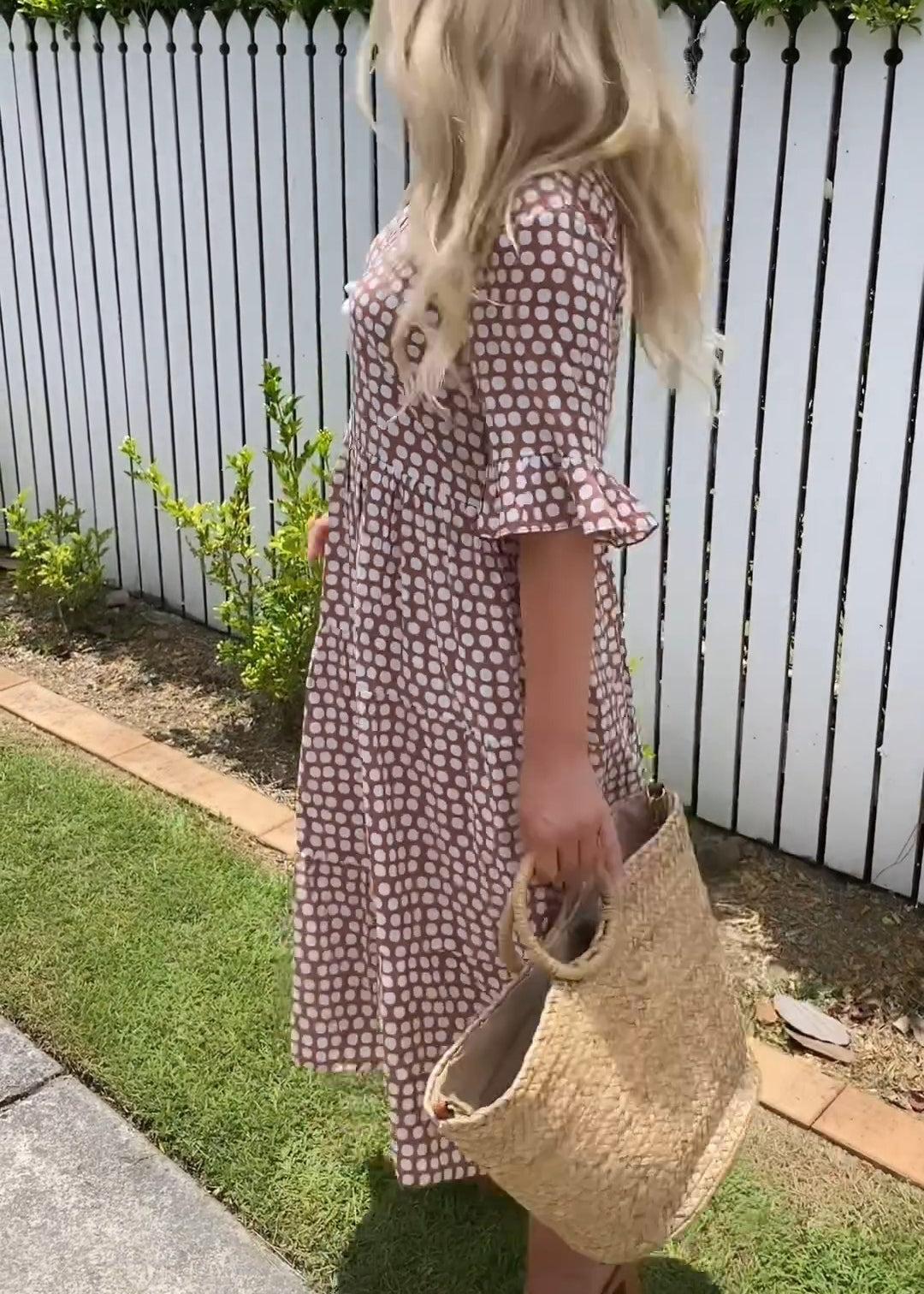 Brown dot-print summer dress with ruffled short sleeves and flower applique