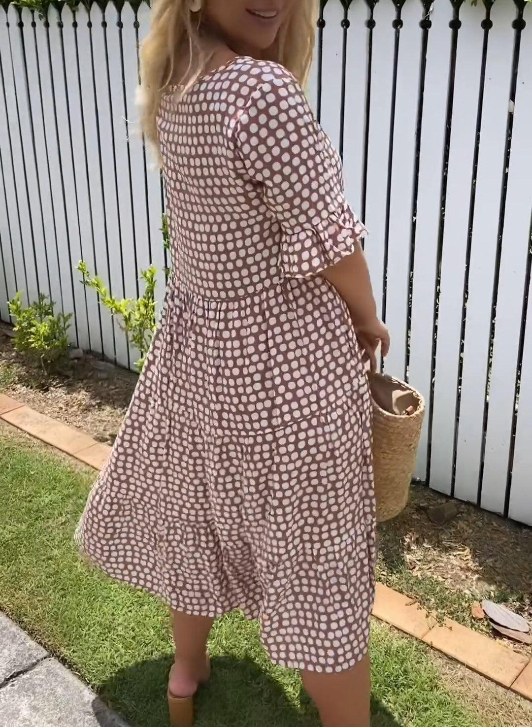 Brown dot-print summer dress with short puff sleeves, flower applique, tiered skirt
