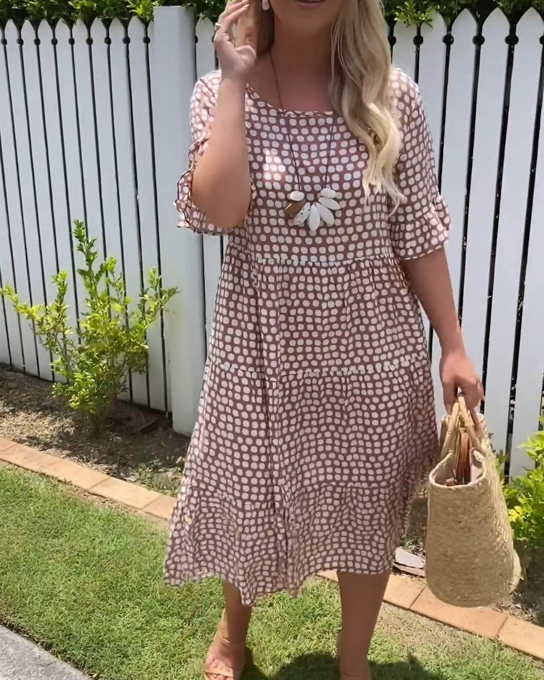 Brown dot-print summer dress with flower applique and cinched waist tiers