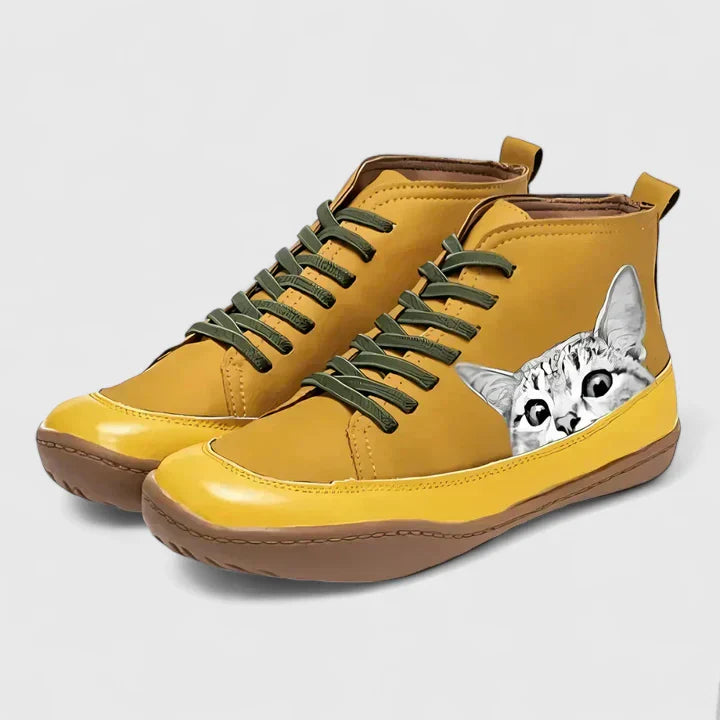 Yellow lace-up orthopedic boots with gray cat face patch and cushioned sole