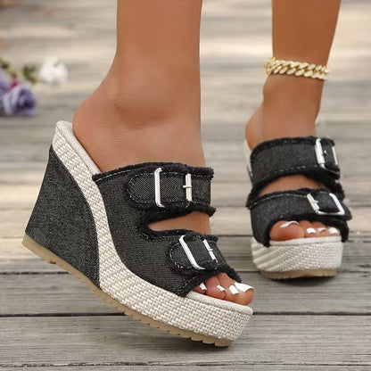 Black wedge sandals with two buckle straps and open toe, textured platform sole