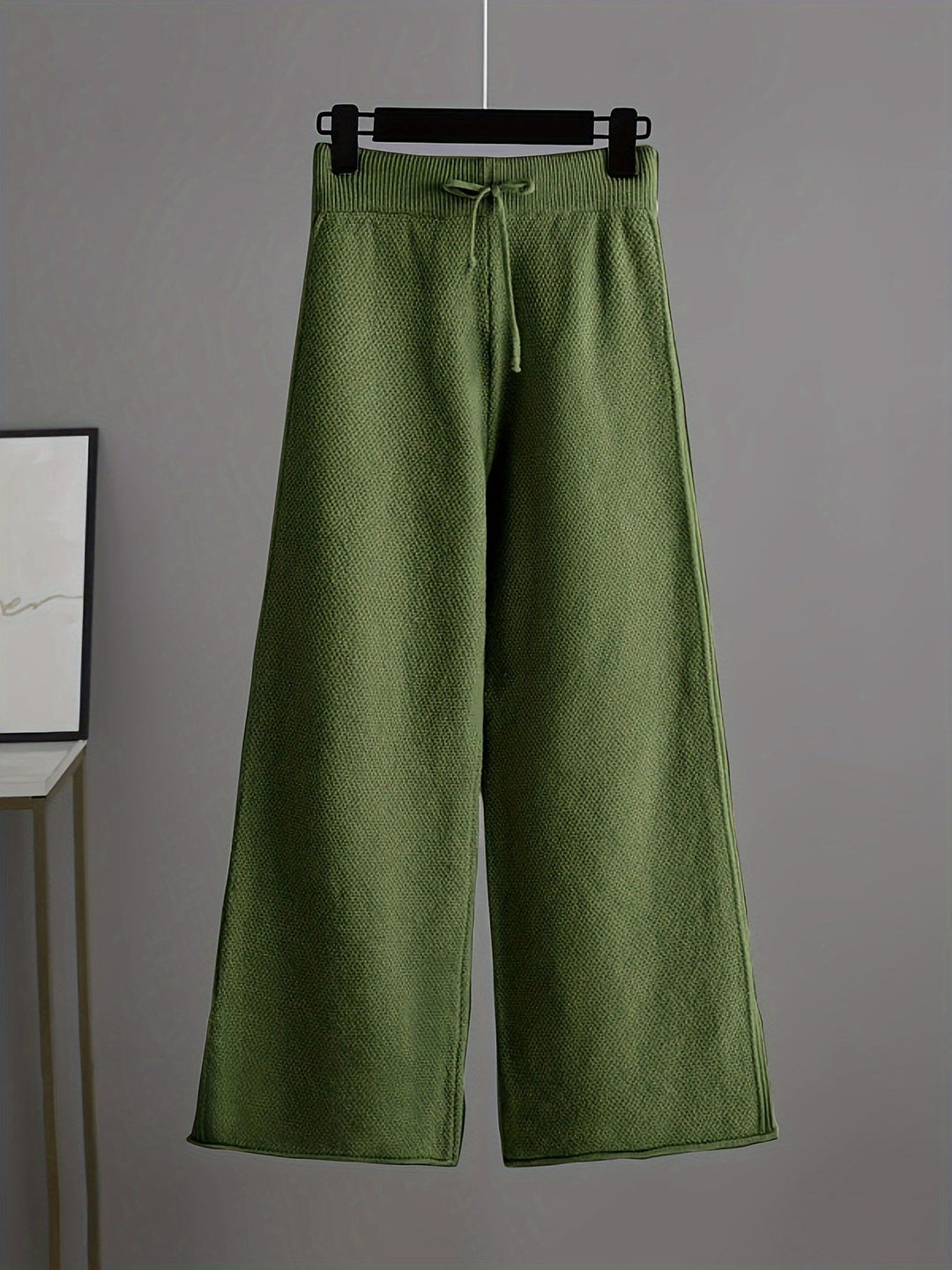 Olive green wide-leg knit trousers with drawstring waistband