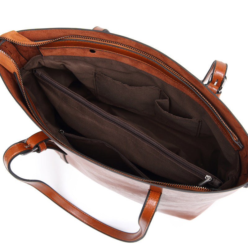 Women’s brown leather crossbody bag interior with zipper pocket and fabric lining