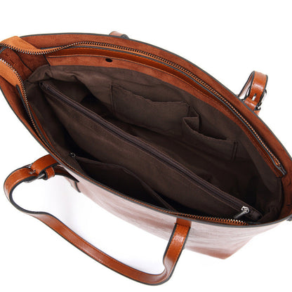 Women’s brown leather crossbody bag interior with zipper pocket and fabric lining