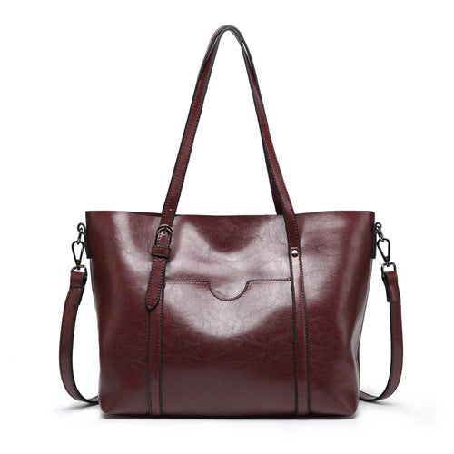 Women’s leather-look crossbody bag in dark brown, with top flap and adjustable strap.