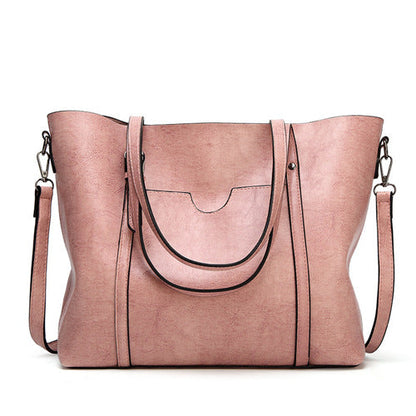 Women’s leather-look crossbody bag in pink, with top flap and adjustable shoulder strap.