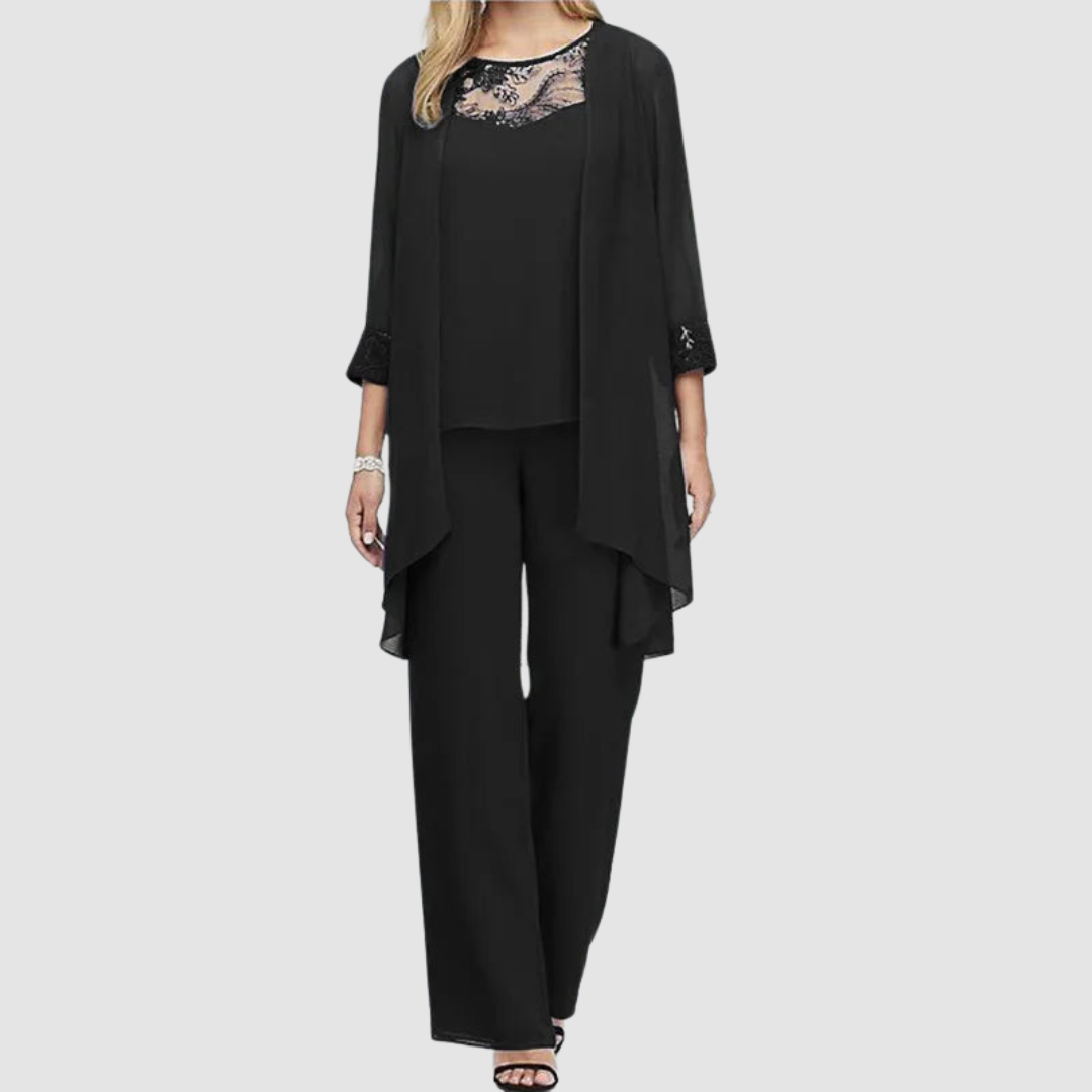 Black three-piece set: lace-trim top, draped jacket, matching tapered trousers.
