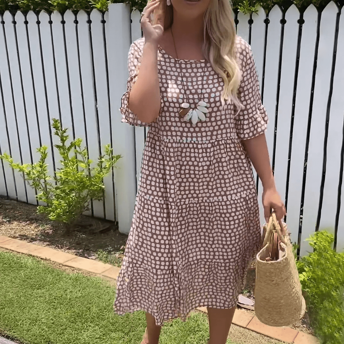 Brown dot-print summer dress with flower applique and tiered skirt