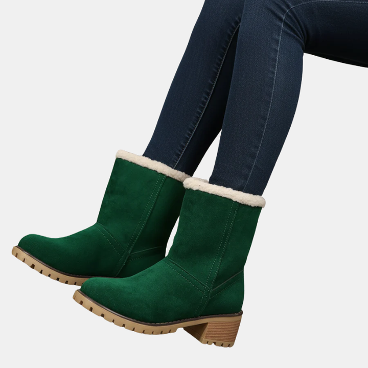 Women’s dark green ankle boots with sherpa trim around the cuff and block heel