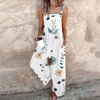 White sleeveless floral overalls with blue leaves and orange flowers, wide legs.