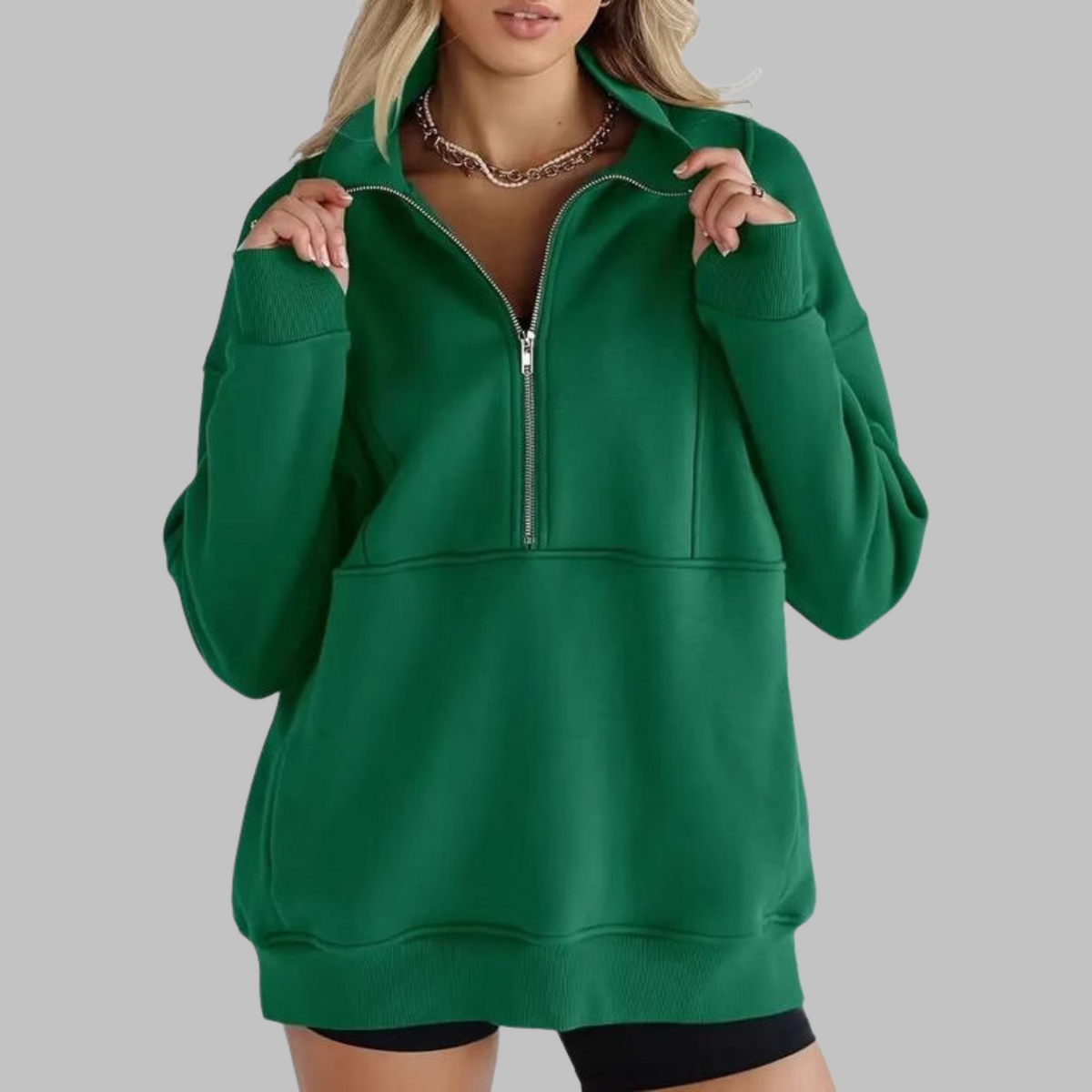 Green oversized half-zip long sleeve sweatshirt with ribbed cuffs, collar, and front pocket