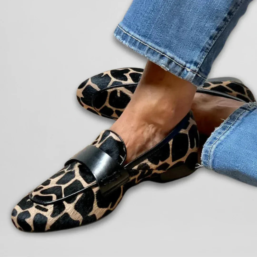 Leopard print moccasin flats with black strap and silver buckle detail
