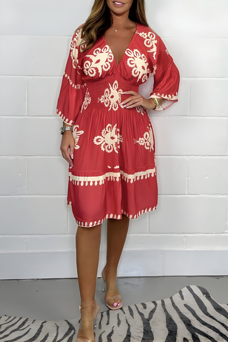 Red knee-length dress with white embroidered florals and tassel-trim hem