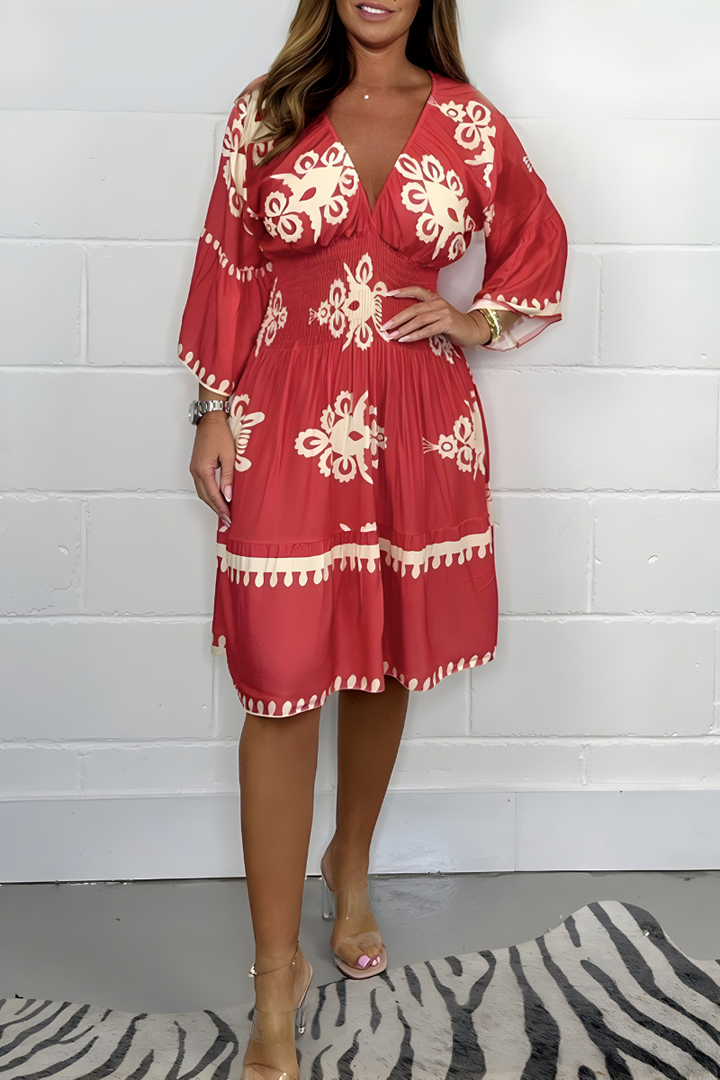 Red knee-length dress with white embroidered florals and tassel-trim hem