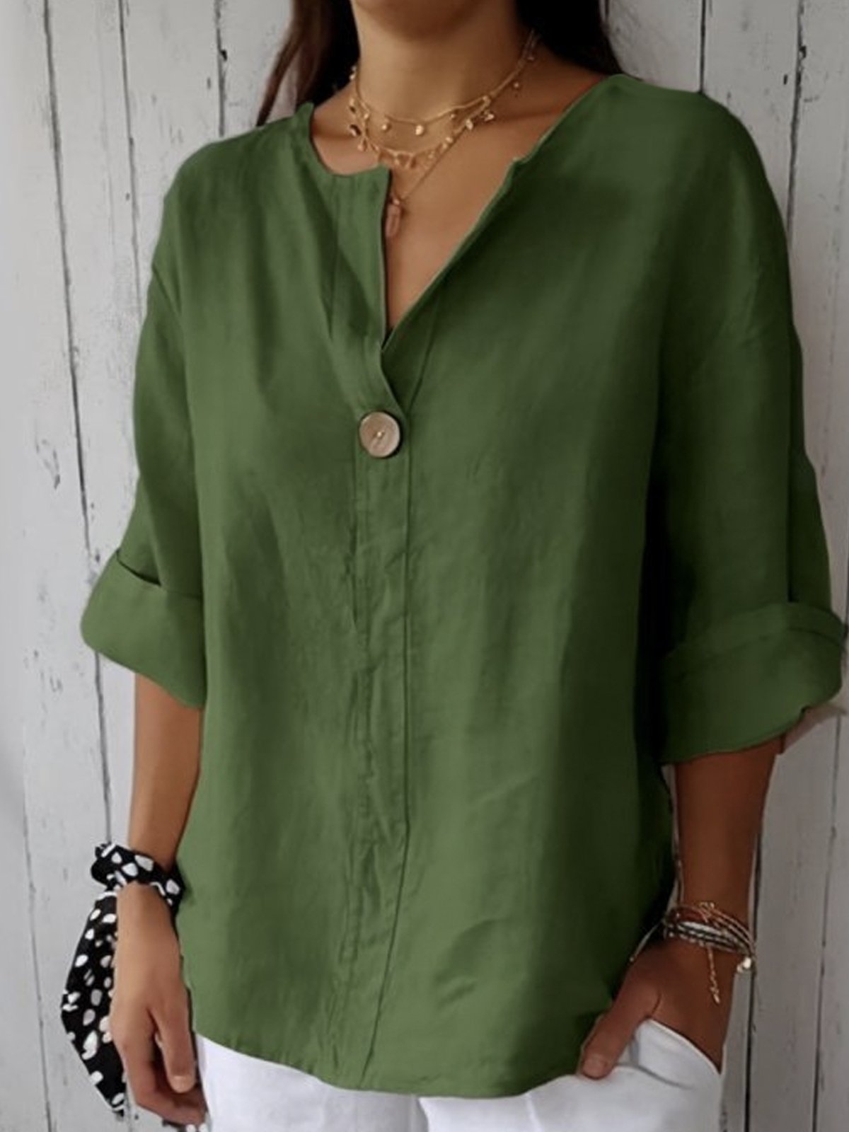 Green V-neck blouse with button front and elbow-length sleeves