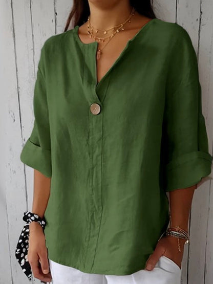 Green V-neck blouse with button front and elbow-length sleeves