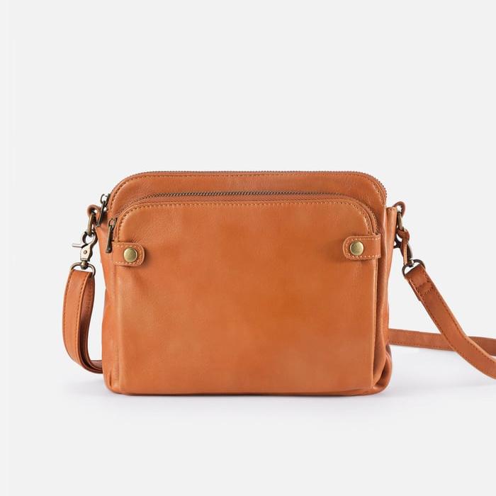 Tan sleek crossbody bag with zip top, two front pockets, and adjustable shoulder strap
