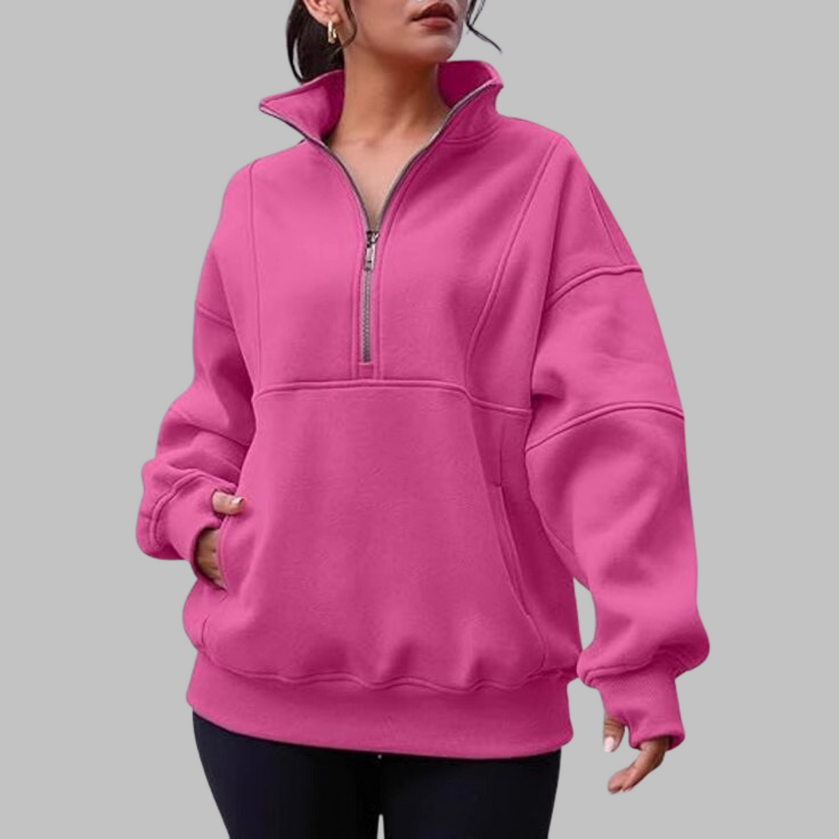 Pink/magenta oversized half-zip long sleeve sweatshirt with ribbed cuffs, collar, and front pocket