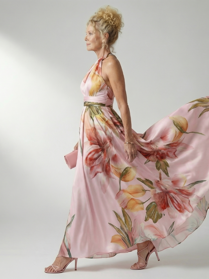 Amiel floral maxi dress side view, halter neck and sash belt, pink with colorful blossoms