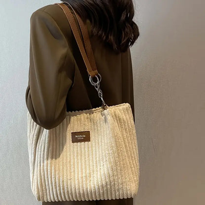 Large corduroy tote bag in pale yellow with shoulder strap and top zipper pocket