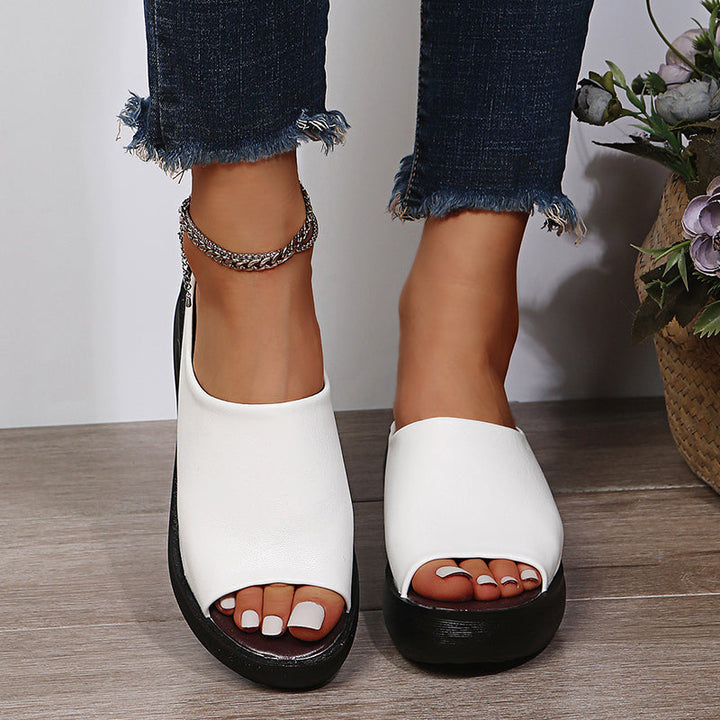 Pair of white orthopedic slide sandals with wide open toe and thick black sole