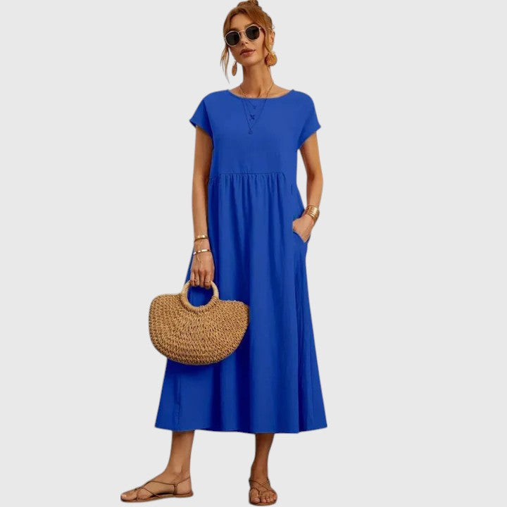 Blue midi dress with short sleeves and gathered waist seam; relaxed fit.