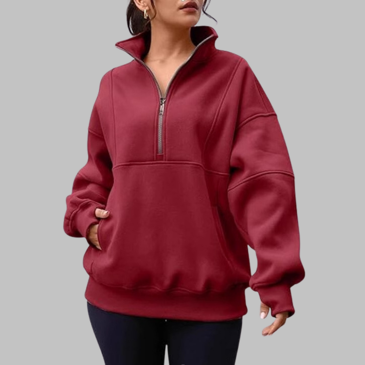 Burgundy oversized half-zip long sleeve sweatshirt with ribbed cuffs, collar, and front pocket