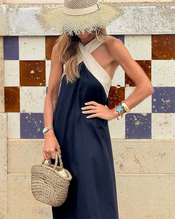 Sleeveless maxi dress in dark blue with crossed halter V-neck and draped skirt