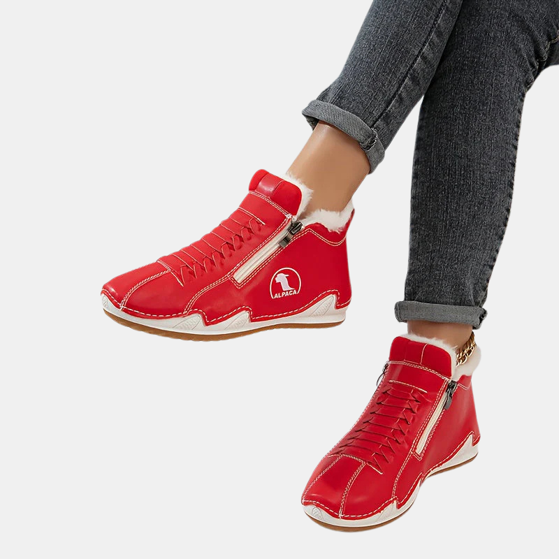 Red ankle boots with faux fur trim, side zipper, lace-up front, and tan rubber sole.