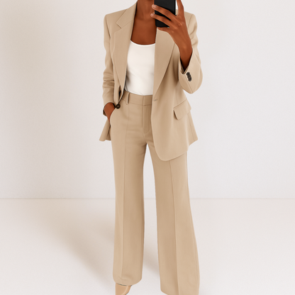 Cream two-piece suit set with tailored blazer and matching trousers, notched lapel and flap pockets.