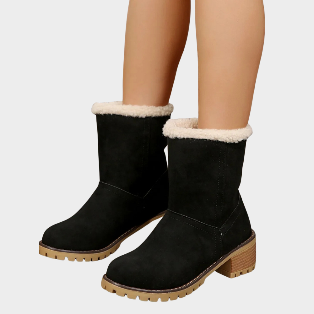 Black suede mid-heel winter boots with white sherpa cuff and brown tread sole
